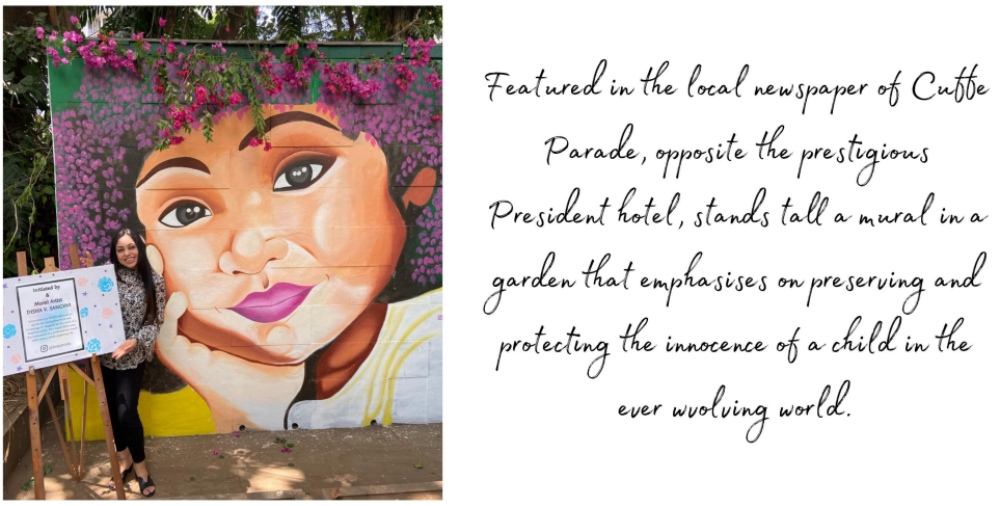 Large outdoor mural of a child’s portrait painted in a public garden space.