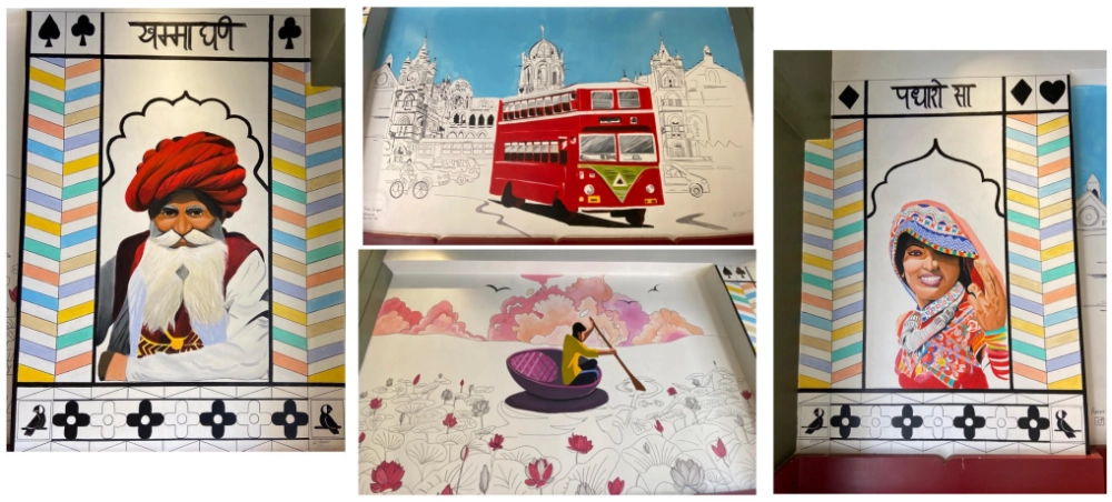 Hand-painted café wall mural featuring cultural portraits and travel-inspired illustrations.